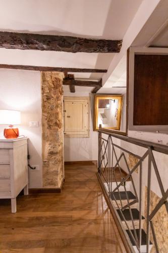 a room with a staircase and a stone wall at Caveau in Palermo