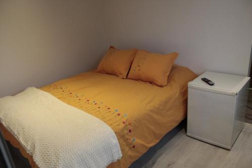 a small bedroom with a bed with polka dots on it at La Tiny House in Ushuaia