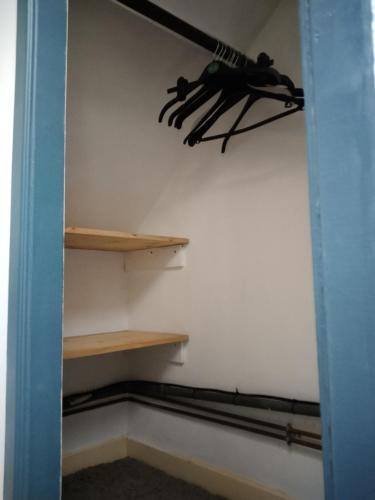 a closet with wooden shelves and a bunch of tools at Craftycotta in Glomel