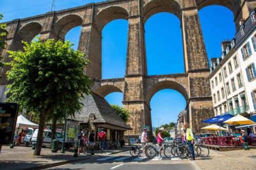 a group of people riding bikes under a bridge at Longère rénovée avec accès direct à la mer in Guimaëc