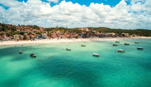 an aerial view of a beach with boats in the water at Maragobeach Suits in Maragogi