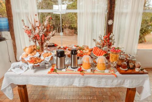 a table with a buffet of food on it at Pouso dos Querubins in Tiradentes