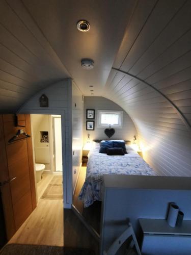 a room with a bed in a small room at The Pod - Luxury Glamping Holiday Lodge in Arley