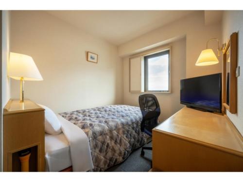 a hotel room with a bed and a desk with a television at Green Hotel Omagari - Vacation STAY 19280v in Daisen