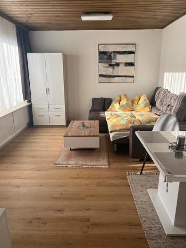 a living room with a couch and a table at living Appartement in Flachau