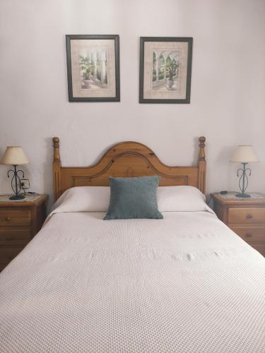 a bedroom with a white bed with two nightstands and two lamps at PUNTA SOL in Isla del Moral