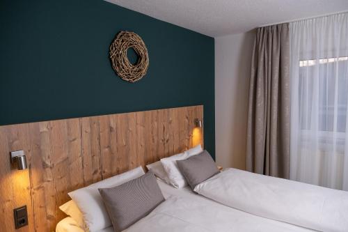 a bedroom with a bed and a mirror on the wall at Gasthaus Hotel Kranz in Laufenburg