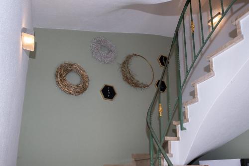 a stairway with wreaths on the wall at Gasthaus Hotel Kranz in Laufenburg