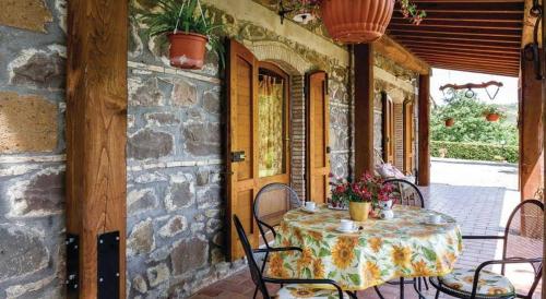 a patio with a table and chairs on a stone building at Agriturismo San Luciano in Radicofani