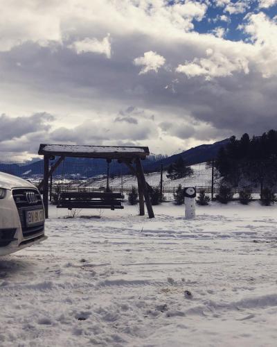 a picnic shelter in a parking lot in the snow at View Piatra Craiului in Zărneşti