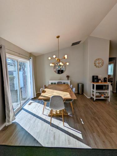 a dining room with a table and chairs and a chandelier at Contemporary 2-Bedroom Close to Downtown, Dining in Eugene