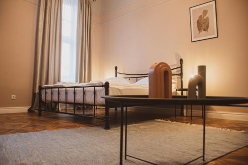 a bedroom with a bed and a table in it at Allegro apartments city center in Oradea