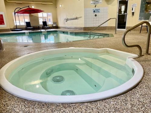 a large tub in the middle of a swimming pool at Super 8 by Wyndham Edmonton South in Edmonton