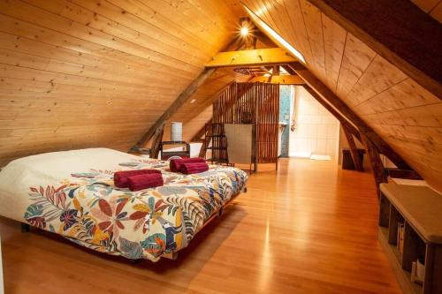 1 dormitorio con 1 cama en un ático de madera en L'escapade en baie, en Abbeville