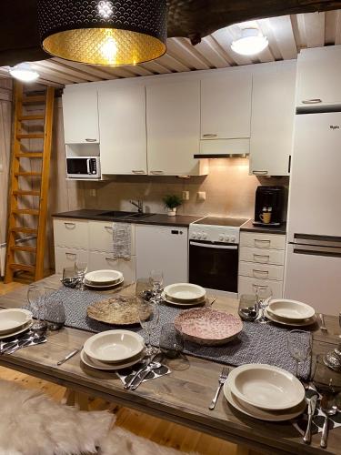 una cocina con una mesa con platos y platos. en Ruka Chalet Roma, en Ruka