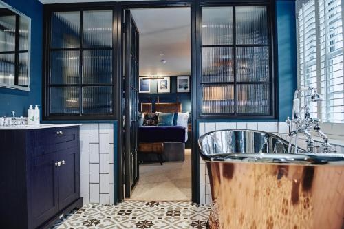 a bathroom with two sinks and a living room at Kings Arms in Egham