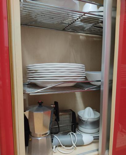 a cupboard filled with plates and a blender at El Chalet Rosso in Guarnizo