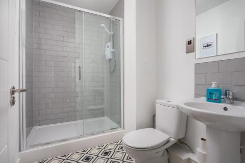 a bathroom with a shower and a toilet and a sink at The Post House One in Gloucester