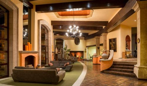 a living room with couches and a fireplace at Quinta Real Zacatecas in Zacatecas