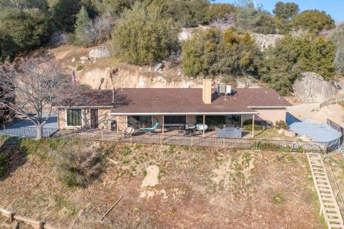 an aerial view of a house with a mountain at Mountain Trail Lodge and Vacation Rentals in Oakhurst