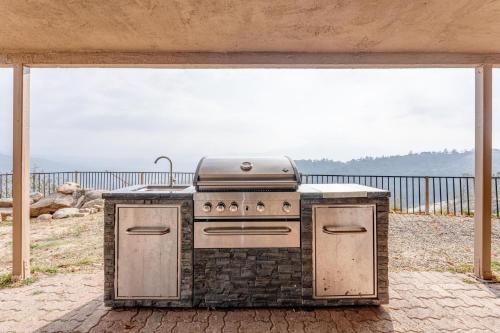 an outdoor kitchen with a stove on a patio at Mountain Trail Lodge and Vacation Rentals in Oakhurst