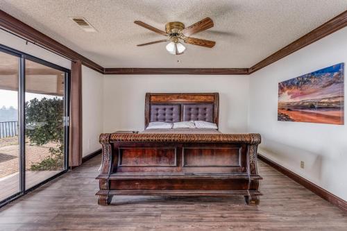 a bedroom with a bed and a ceiling fan at Mountain Trail Lodge and Vacation Rentals in Oakhurst