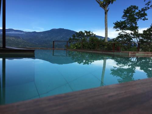a swimming pool with a view of the mountains at Bella Vista Ranch Ecolodge in Turrialba