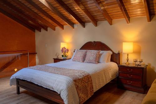 a bedroom with a bed with two night stands and two lamps at Fantástico Loft Centro Histórico Quito in Quito