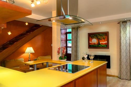 eine Küche mit gelber Arbeitsplatte und ein Wohnzimmer in der Unterkunft Fantástico Loft Centro Histórico Quito in Quito