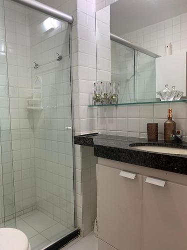 a bathroom with a shower and a toilet and a sink at Monte Castelo Gravatá in Gravatá