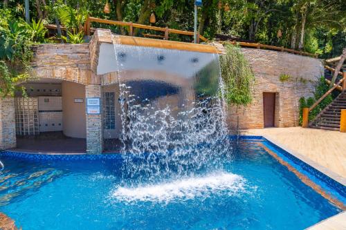 a water fountain in a swimming pool at Best Western Shalimar Praia Hotel in Porto Seguro