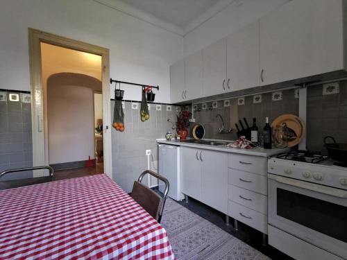 a kitchen with a red and white checkered table cloth at casa da vila in Mora