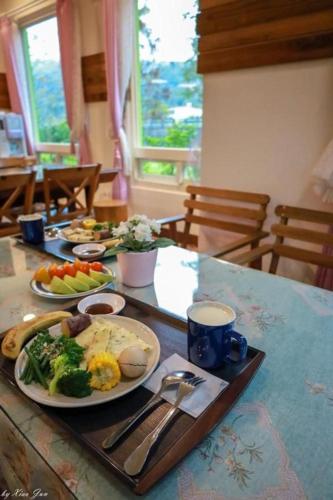 a table with plates of food on top of it at DooDoo B&B in Jiji