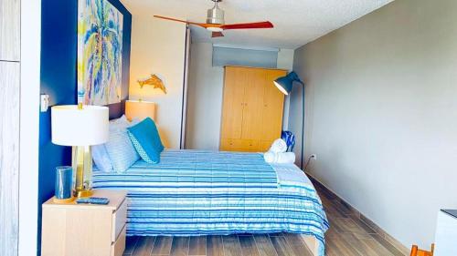 a bedroom with a bed and a ceiling fan at KASA Starfish by the Sea - 8th floor Studio Apt for 2 BALCONY Ocean City View in San Juan
