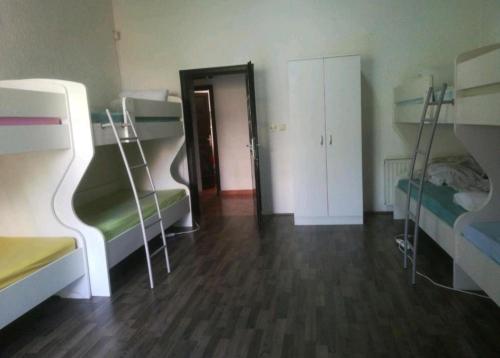 a room with two bunk beds and a hallway at Stars Aspava Blue HOSTEL in Podgorica