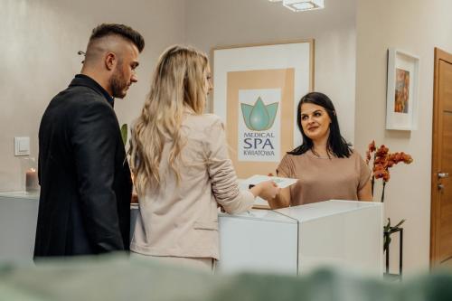 a group of three people standing in a room at Medical Spa Kwiatowa in Łęczyca