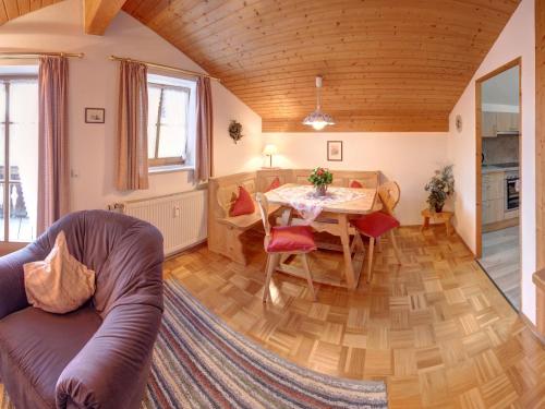 a living room with a table and a couch at Beim Bretzner - Chiemgau Karte in Inzell