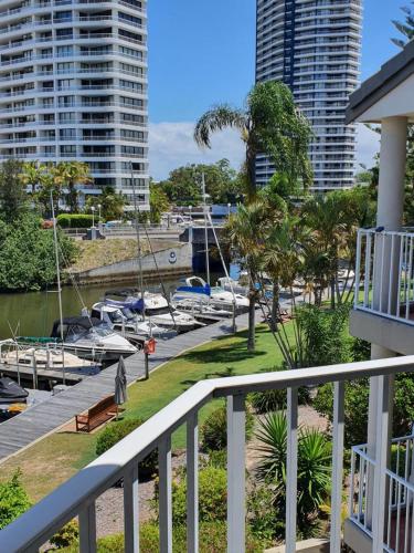 a balcony with boats in a marina with tall buildings at Bayview Bay Apartments and Marina in Gold Coast