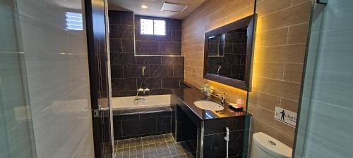a bathroom with a sink and a shower at The Room Boutique Hotel in Sakon Nakhon