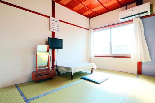 Postel nebo postele na pokoji v ubytování Marumo Ryokan
