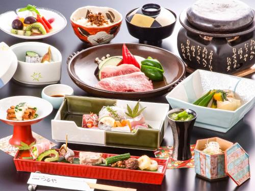 a table with various dishes of food on it at AsoTsuruya in Aso