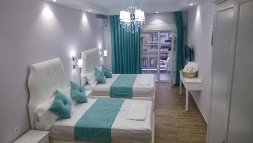 2 camas en una habitación con verde y blanco en Apartments Flower Residence, en Sarandë