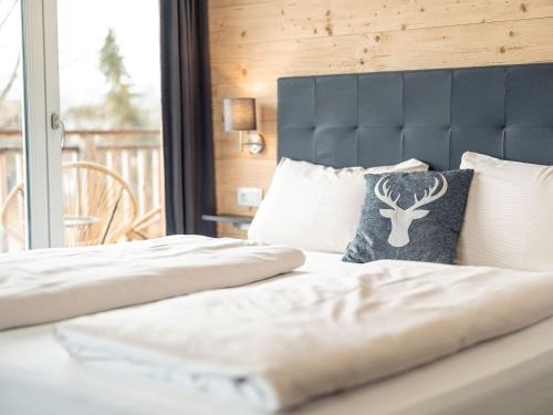 a bedroom with two beds with a blue headboard at Inzell Chalets with private pool in Inzell