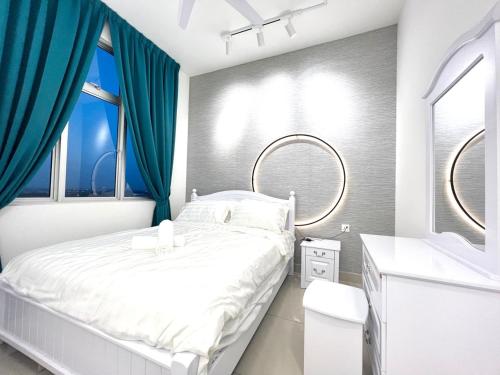 a bedroom with a white bed and blue curtains at SKS Habitat 461 2BR 4-5pax Larkin Johor Bahru in Johor Bahru