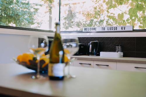 a bottle of wine sitting on a counter in a kitchen at Lusso KV in Whitfield
