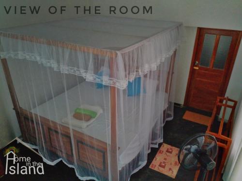 a room with a bed with a curtain at Home in the Island in Tangalle