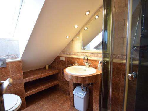 a bathroom with a sink and a shower at holiday home, Swibno in Świbno