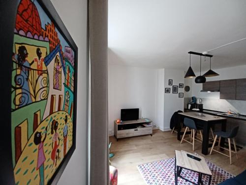 a kitchen and a living room with a dining room at DIEPPE au coeur du cville-Calme avec balcon in Dieppe