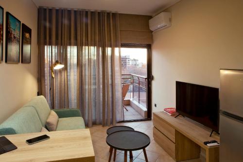 a living room with a couch and a television at Designer apartments close to the center + free parking in Thessaloniki