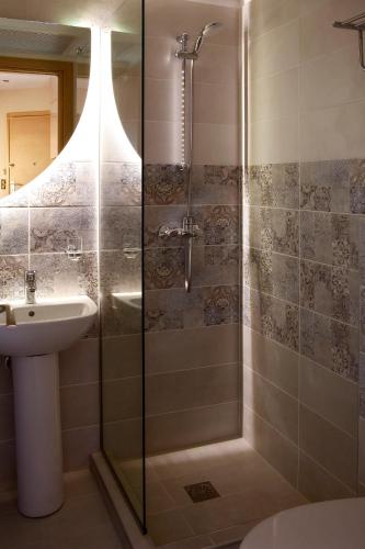 a bathroom with a shower and a sink at Designer apartments close to the center + free parking in Thessaloniki